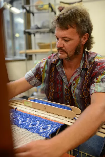Anthony Carter, the “Cowboy Weaver,” working on his loom in the Appalachian Artisan Center in Hindman, KY.