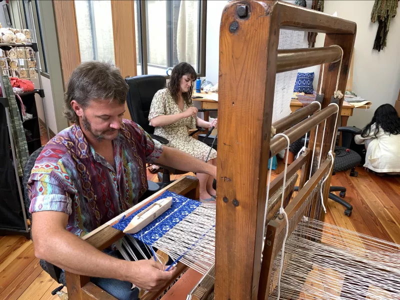 Anthony Carter, the “Cowboy Weaver,” working on his loom in the Appalachian Artisan Center in Hindman, KY.