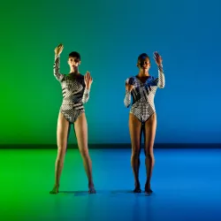 Two dancers with blue and green backgroun
